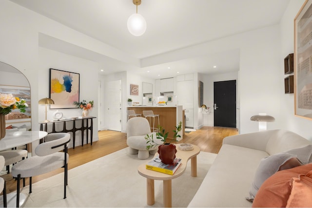 living area featuring light wood-style floors and recessed lighting