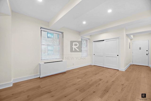 entryway with beam ceiling, light wood-style flooring, recessed lighting, and baseboards