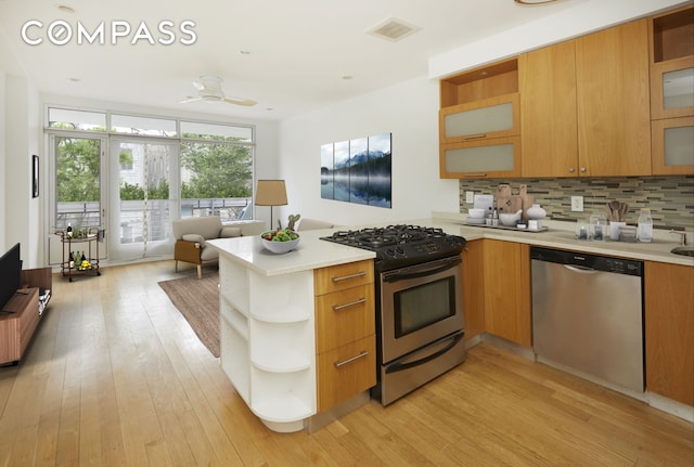 kitchen featuring tasteful backsplash, visible vents, appliances with stainless steel finishes, a peninsula, and open shelves