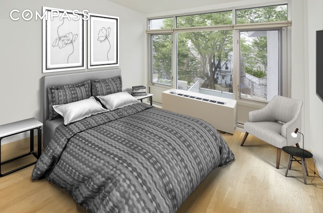 bedroom featuring wood finished floors and radiator heating unit