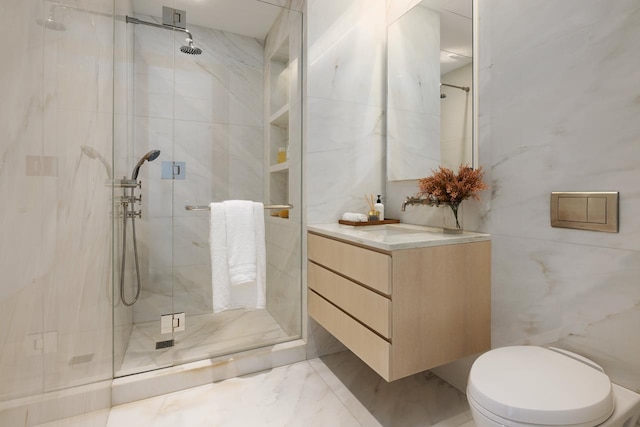 bathroom with a shower stall, vanity, and marble finish floor