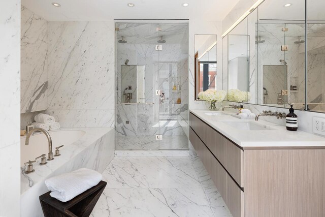 bathroom with a marble finish shower, stone wall, tile walls, and a sink