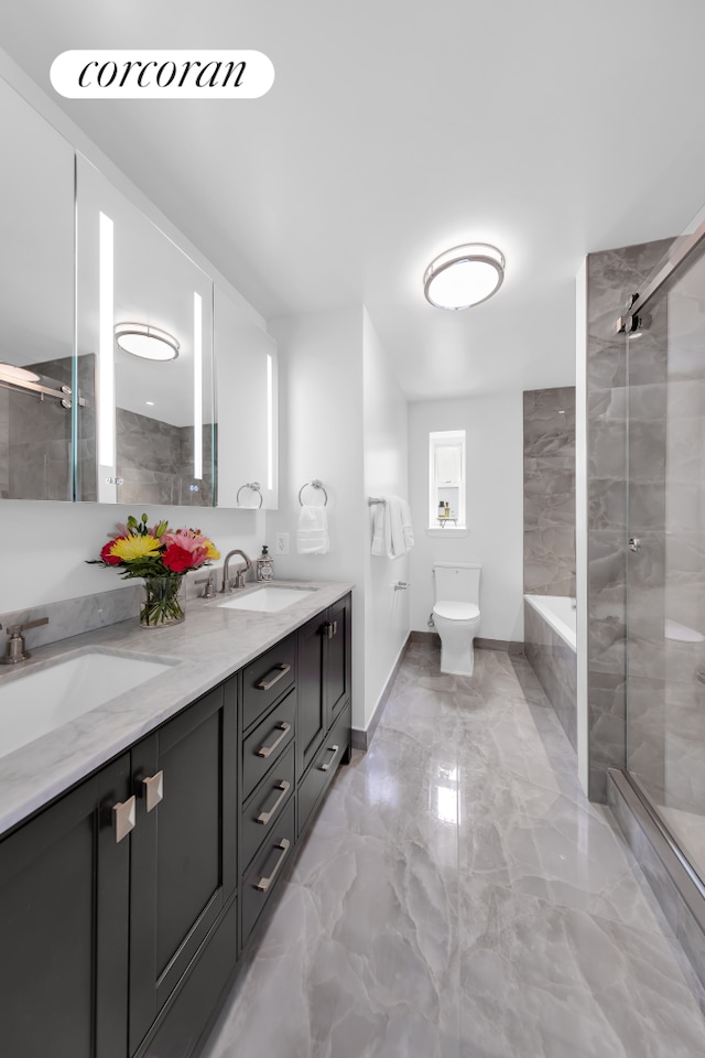 bathroom featuring marble tiled flooring, a stall shower, double vanity, toilet, and baseboards