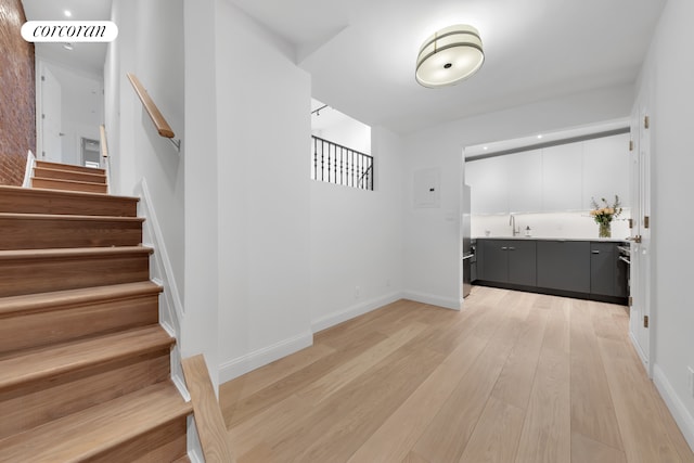 staircase with wood finished floors and baseboards
