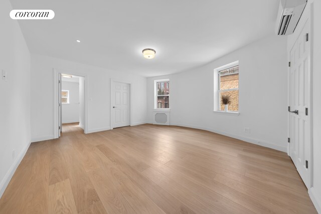 interior space with visible vents, baseboards, and wood finished floors