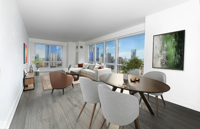 dining room featuring a view of city, wood finished floors, and baseboards