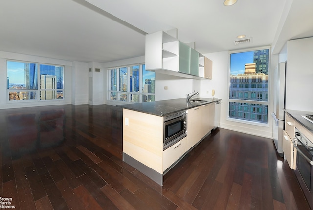 kitchen featuring open shelves, dark wood finished floors, visible vents, and stainless steel appliances