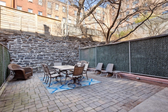 view of patio / terrace featuring fence and outdoor dining area