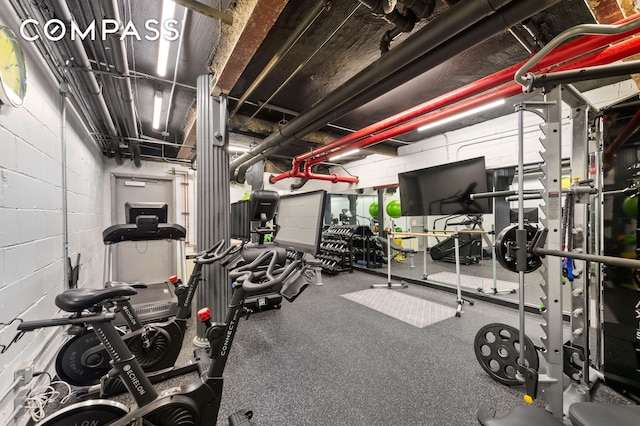 workout area featuring concrete block wall