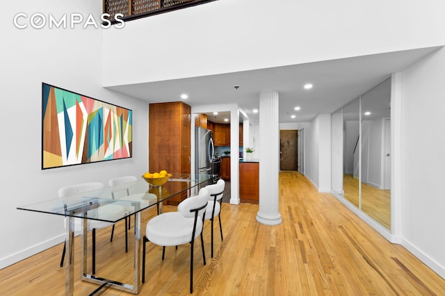 dining space with light wood finished floors, decorative columns, baseboards, and recessed lighting