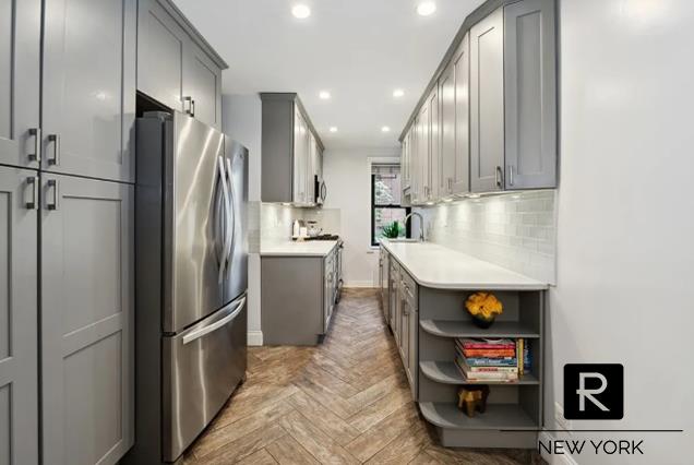 100-11 67th Rd Unit 106, New York City, NY 11375 - kitchen with stainless steel appliances, gray cabinetry, a sink, recessed lighting, and light countertops