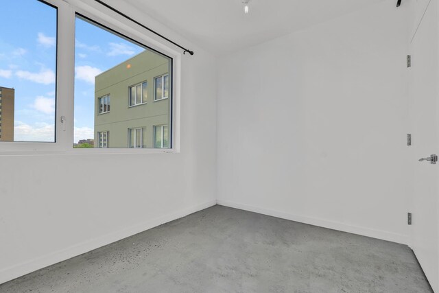 651 New York Ave Unit 502, New York City, NY 11203 - spare room with concrete flooring and baseboards