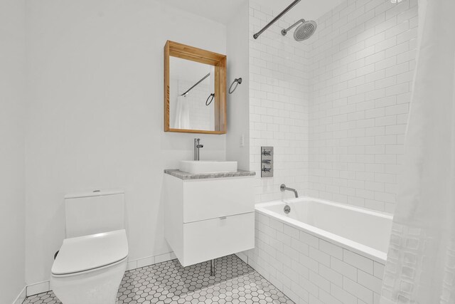 651 New York Ave Unit 502, New York City, NY 11203 - full bath with toilet, tiled shower / bath, vanity, tile patterned flooring, and baseboards