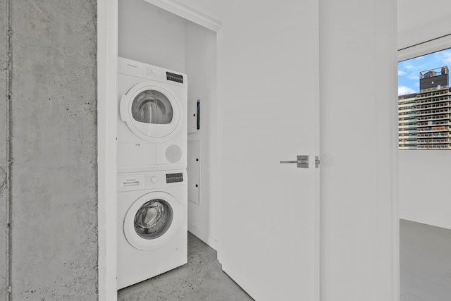 washroom featuring laundry area and stacked washing maching and dryer