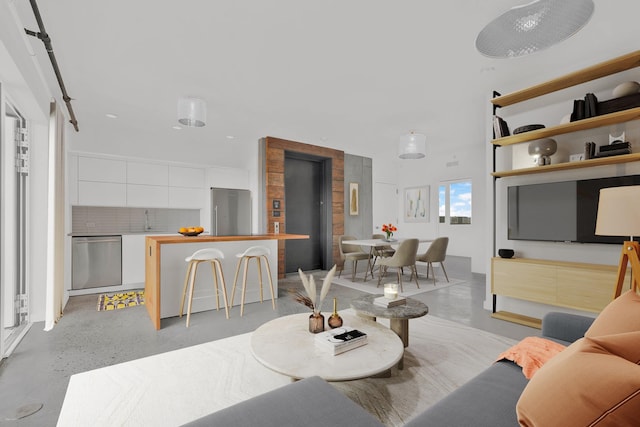 living room featuring finished concrete floors
