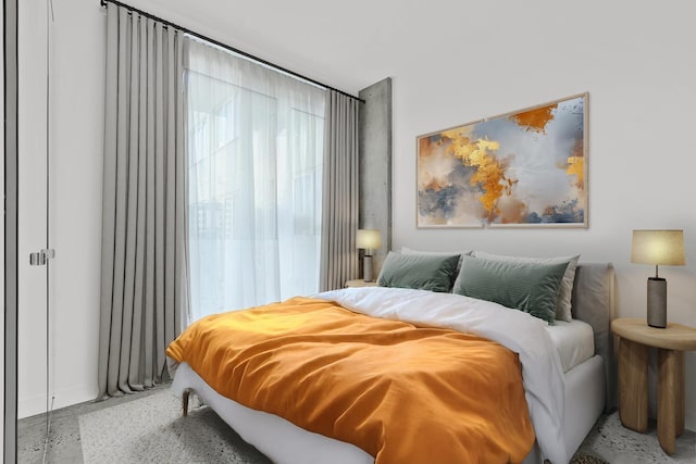 bedroom featuring baseboards and speckled floor