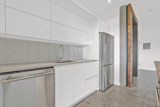 kitchen with white cabinets, stainless steel appliances, modern cabinets, and a sink