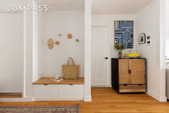 interior space featuring baseboards and light wood-style floors