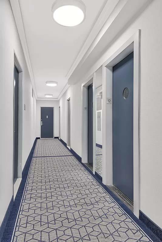 hallway with baseboards and ornamental molding