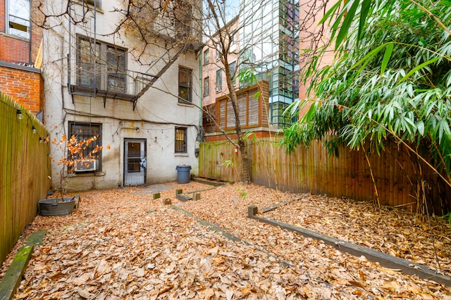 131 E 29th St, New York City, NY 10016 - back of house featuring a fenced backyard and brick siding