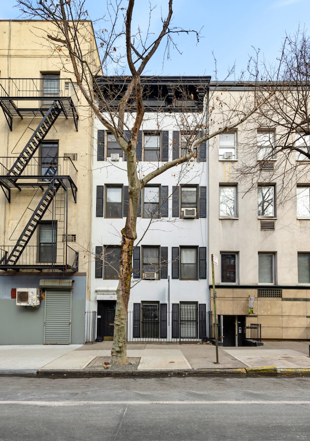 view of property with an AC wall unit