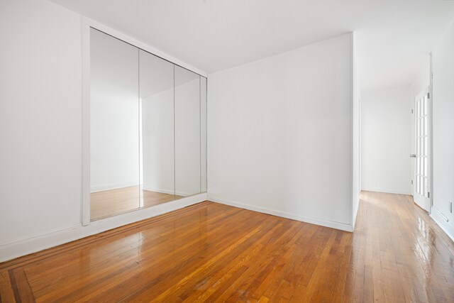 131 E 29th St, New York City, NY 10016 - unfurnished bedroom with wood-type flooring and a closet