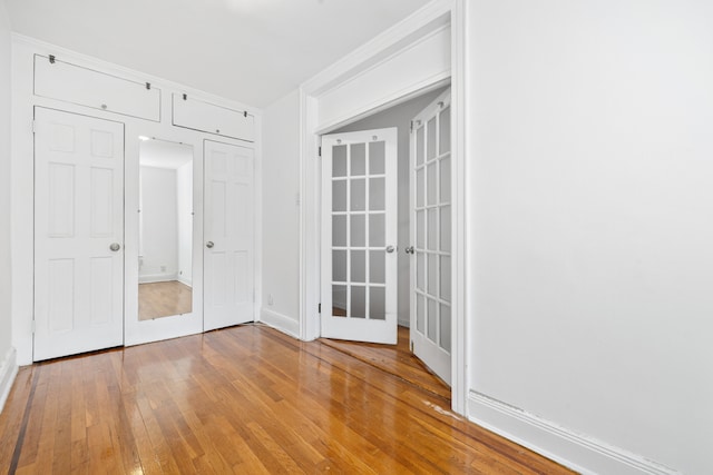 131 E 29th St, New York City, NY 10016 - empty room featuring french doors and hardwood / wood-style floors