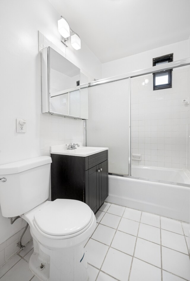 131 E 29th St, New York City, NY 10016 - full bathroom featuring vanity, bath / shower combo with glass door, and tile patterned flooring