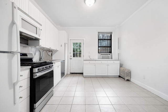 131 E 29th St, New York City, NY 10016 - kitchen with stainless steel appliances, radiator, ornamental molding, light countertops, and white cabinets