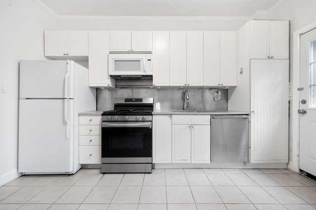 131 E 29th St, New York City, NY 10016 - kitchen with stainless steel appliances, light countertops, ornamental molding, white cabinetry, and decorative backsplash