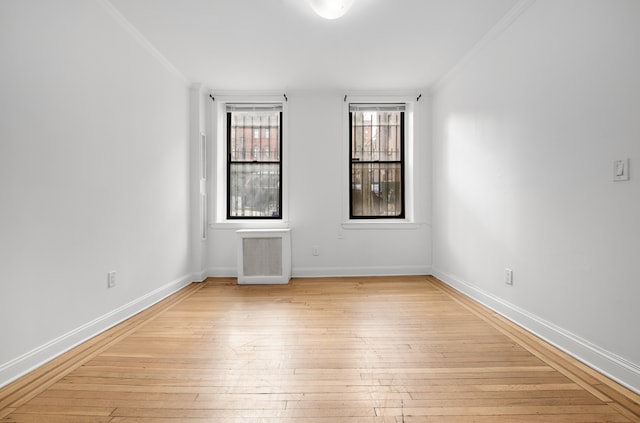 131 E 29th St, New York City, NY 10016 - unfurnished room featuring light wood-type flooring, crown molding, and radiator