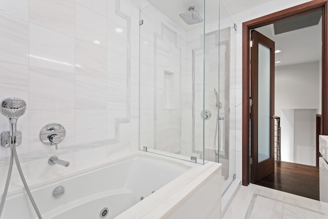 bathroom with a shower stall and a whirlpool tub