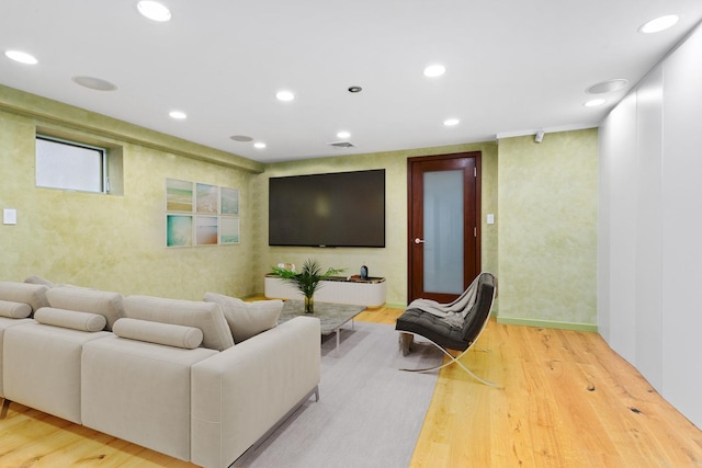 living room with visible vents, recessed lighting, and wood finished floors