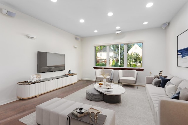 living room featuring recessed lighting and baseboards