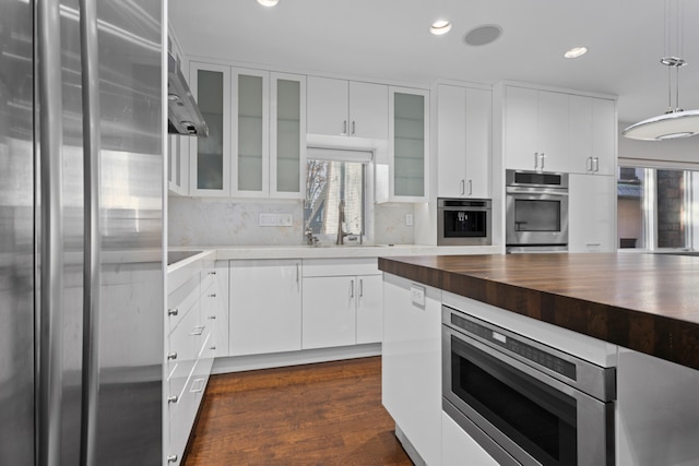 kitchen featuring a sink, recessed lighting, appliances with stainless steel finishes, white cabinets, and butcher block counters