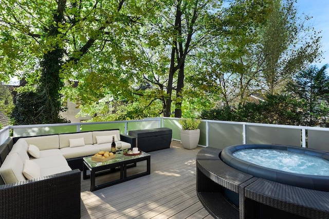 wooden deck with an outdoor hot tub and an outdoor hangout area