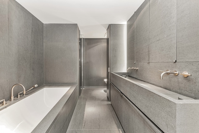 full bathroom with a garden tub, vanity, an enclosed shower, and toilet