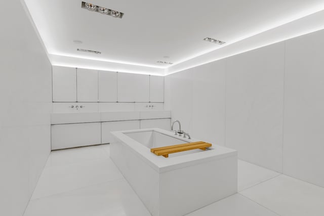 bathroom featuring a soaking tub, visible vents, and tile patterned flooring