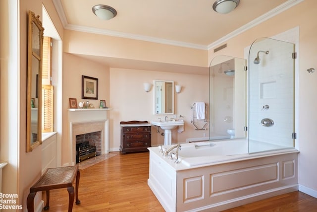 1 Beekman Pl Unit 7/8A, New York City, NY 10022 - full bathroom featuring a tub, a fireplace with flush hearth, wood finished floors, a shower, and ornamental molding