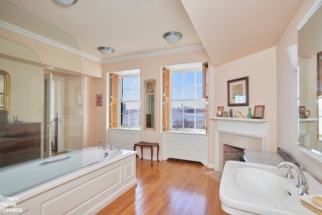 1 Beekman Pl Unit 7/8A, New York City, NY 10022 - full bathroom featuring a bath, a fireplace, wood finished floors, crown molding, and a shower