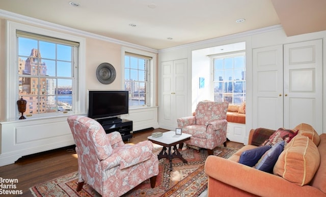 1 Beekman Pl Unit 7/8A, New York City, NY 10022 - living area with dark wood-type flooring, a decorative wall, ornamental molding, and wainscoting