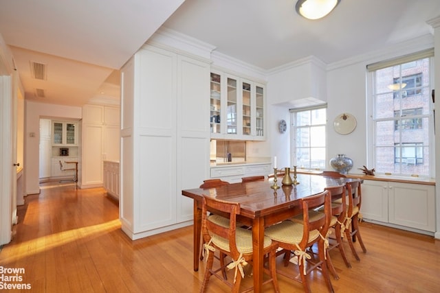 1 Beekman Pl Unit 7/8A, New York City, NY 10022 - dining room featuring light wood-type flooring and crown molding