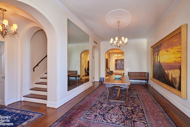1 Beekman Pl Unit 7/8A, New York City, NY 10022 - hall featuring a chandelier, wood finished floors, arched walkways, stairway, and ornamental molding
