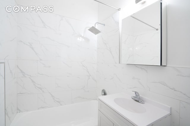 bathroom featuring bathtub / shower combination and vanity