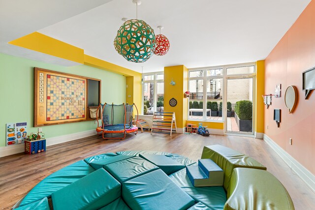 playroom with wood finished floors and baseboards