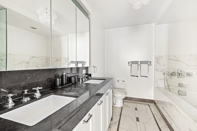 bathroom featuring marble look tiles, toilet, baseboards, a tub to relax in, and double vanity