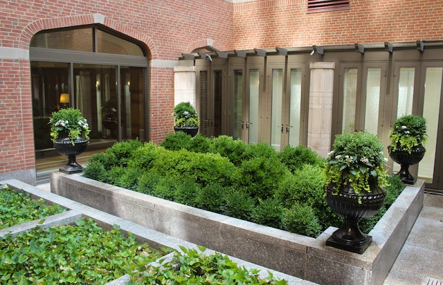 entrance to property featuring brick siding