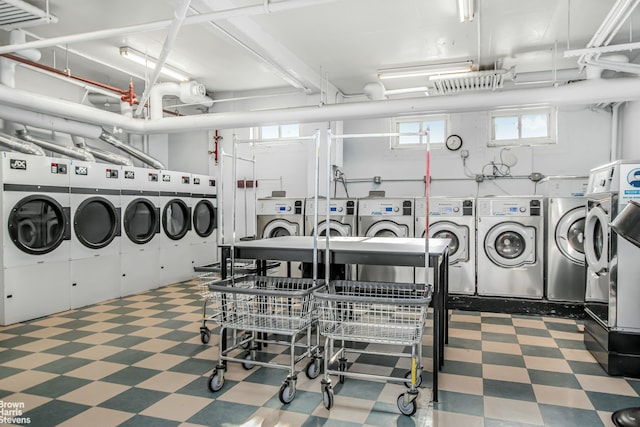 community laundry room featuring washer and dryer and tile patterned floors