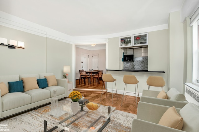 living area featuring ornamental molding