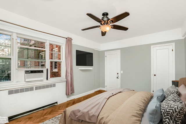 bedroom featuring cooling unit, baseboards, radiator, and ceiling fan